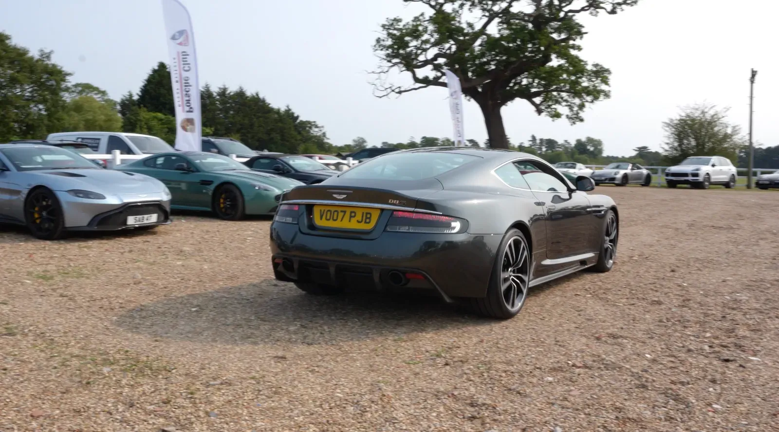 Aston Martins parked on gravel at Royal Berkshire Polo Club during an owners' club hospitality day